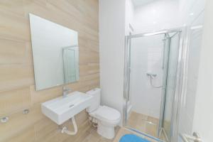 a bathroom with a toilet and a sink and a shower at Victoria Flats in Senglea +9 photos