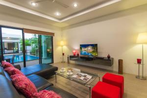 Villa Nc10 في شاطئ راوايْ: غرفة معيشة مع أريكة وتلفزيون