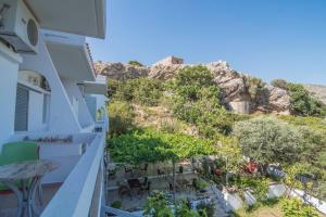 a balcony of a house with a view of the mountains at Megim Hotel in Palaiochora