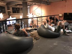 a group of people sitting in bean bags in a room at BED STATION Hostel Ratchthewi in Bangkok