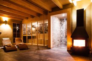 a living room with a fireplace and rocking chairs at Lavender Hill, Eko Resort & Wellness in Polzela