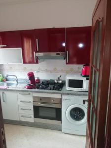 uma cozinha com um fogão e um micro-ondas em LINA APPARTEMENT em Marrakech