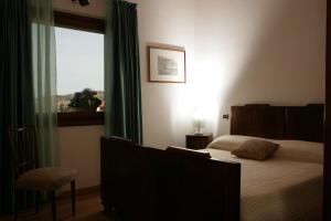 A bed or beds in a room at Alloggio Agrituristico CORTE SAN BIAGIO