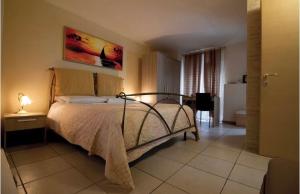 a bedroom with a bed and a table with a lamp at Appartamento Caniglia in Francavilla Fontana
