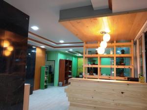 a room with green walls and a wooden counter at Aonang Village Resort in Ao Nang Beach