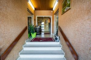 a hallway with stairs leading into a building at Hotel de Champagne in Saint-Dizier