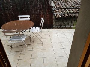 a table and chairs on a tiled patio at Maison meublée 84 mètre carré in Ambérieu-en-Bugey
