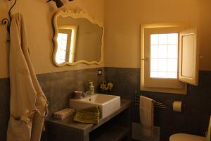 a bathroom with a sink and a mirror at CASADORATA buen retiro vista mare in Donnalucata