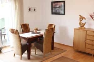 uma sala de jantar com uma mesa de madeira e cadeiras em Ferienhaus am Yachthafen em Greifswald