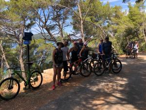 a group of people standing next to bikes on a trail at Luxury Catamaran Lagoon 42, AC & GN in Split