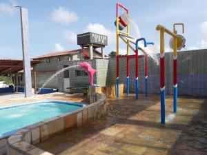 a water park with a pool and a water slide at Pousada Ipê in Salinópolis