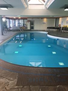 a large swimming pool with blue water in a building at Royal Harbour Resort in Thornbury