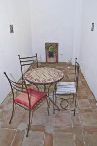 
a table with chairs and a table cloth at Alcoba del Rey de Sevilla in Seville
