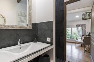 a bathroom with a white sink and a mirror at Petite Maison du Ventoux in Mormoiron +25 photos