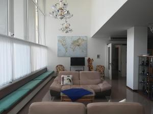 a living room with a couch and a map on the wall at Hotel Ambra in Lignano Sabbiadoro