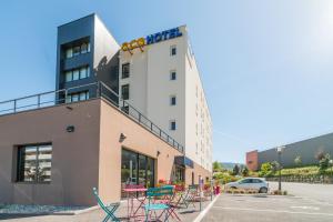 a building with colorful chairs in a parking lot at Ace Hotel Annecy in Annecy