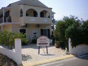 a house with a sign in front of it at Olga Apartments in Agios Georgios +40 photos
