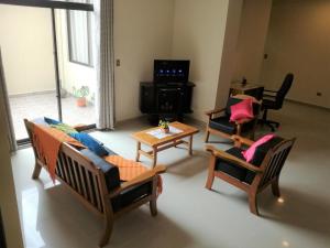 a living room with chairs and a couch and a table at C&R apartments in Cochabamba