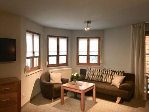 a living room with a couch and a table at Ferienwohnung Alte Poststraße in Kurort Oberwiesenthal