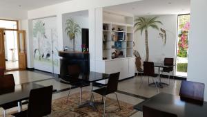 a dining room with a table and chairs in it at Posada de los Pajaros in Punta del Este