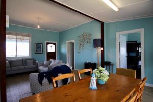 a living room with a dining room table and a couch at Storm Bay View in Augusta