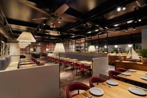 a restaurant with wooden tables and red chairs at Keio Prelia Hotel Kyoto Karasuma-Gojo in Kyoto +48 photos