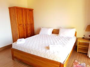 a bedroom with a bed with two towels on it at Free Beach Resort in Phú Quốc