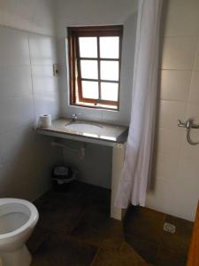 a bathroom with a toilet and a window at El Quincho in San Luis