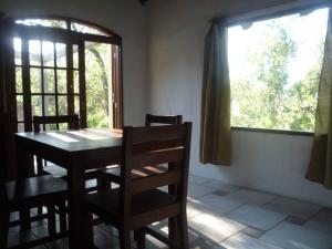 a dining room with a table and chairs and a window at El Quincho in San Luis +7 photos