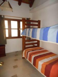 two bunk beds in a room with a window at El Quincho in San Luis