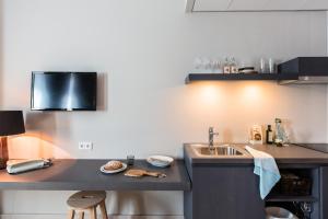 a kitchen with a sink and a counter at Bold Hotel München Giesing in Munich