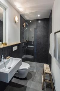 a bathroom with a sink and a toilet and a shower at Bold Hotel München Giesing in Munich