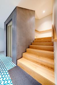 a staircase in a house with wooden floors at Bom Jardim Apartments in Porto