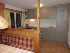 a kitchen with white cabinets and a counter top at Montalin (452 Ti) 2. Stock in Valbella +14 photos