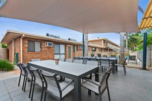 a patio area with a table and chairs at Allambi Holiday Apartments in Lakes Entrance