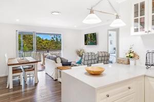 a kitchen and living room with a couch and a table at Red Gum Cottage in Eagle Heights