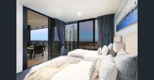 a hotel room with two beds and a large window at Cavill Avenue Luxury Private Apartments in Gold Coast