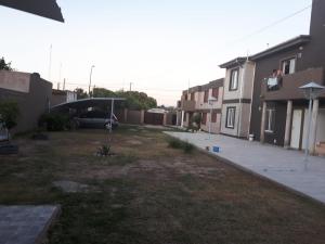 a yard with a car parked in a driveway at Complejo LUMA in Villa Dolores