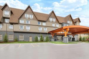a rendering of a building with a parking lot at Super 8 by Wyndham Canmore in Canmore
