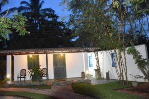 a guest house at night with a chair and trees at Sethra Villa Bentota in Bentota