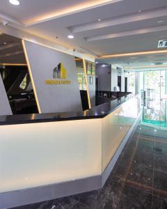 a lobby with a reception counter in a building at Higher Hotel in Bandar Seri Begawan