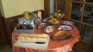 a table with a bunch of bread and food on it at Castellu Rossu in Lucciana
