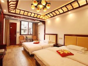 a hotel room with two beds and a chandelier at Xitang River Time Inn in Jiashan