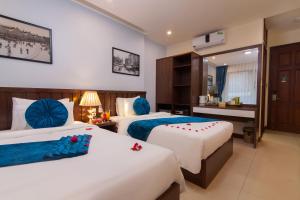 Postel nebo postele na pokoji v ubytování Hanoi Hanvet Hotel