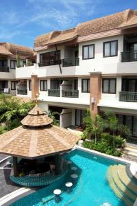 a hotel with a swimming pool and a building at P.P. Palmtree Resort in Phi Phi Don