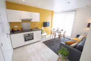 a kitchen and living room with a couch and a table at Studio Brussels Airport - South in Zaventem