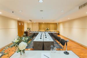 a large conference room with a long table and chairs at Seasons Siam Hotel in Bangkok