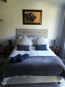 a bed with a person laying on top of it at Apartment in Heather Park in George
