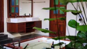 
a bathroom with a sink and a counter top at Villa Cathaya - Private Pool in Pantai Cenang
