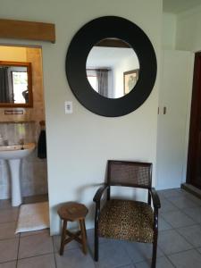 a bathroom with a chair and a mirror on the wall at Apartment in Heather Park in George